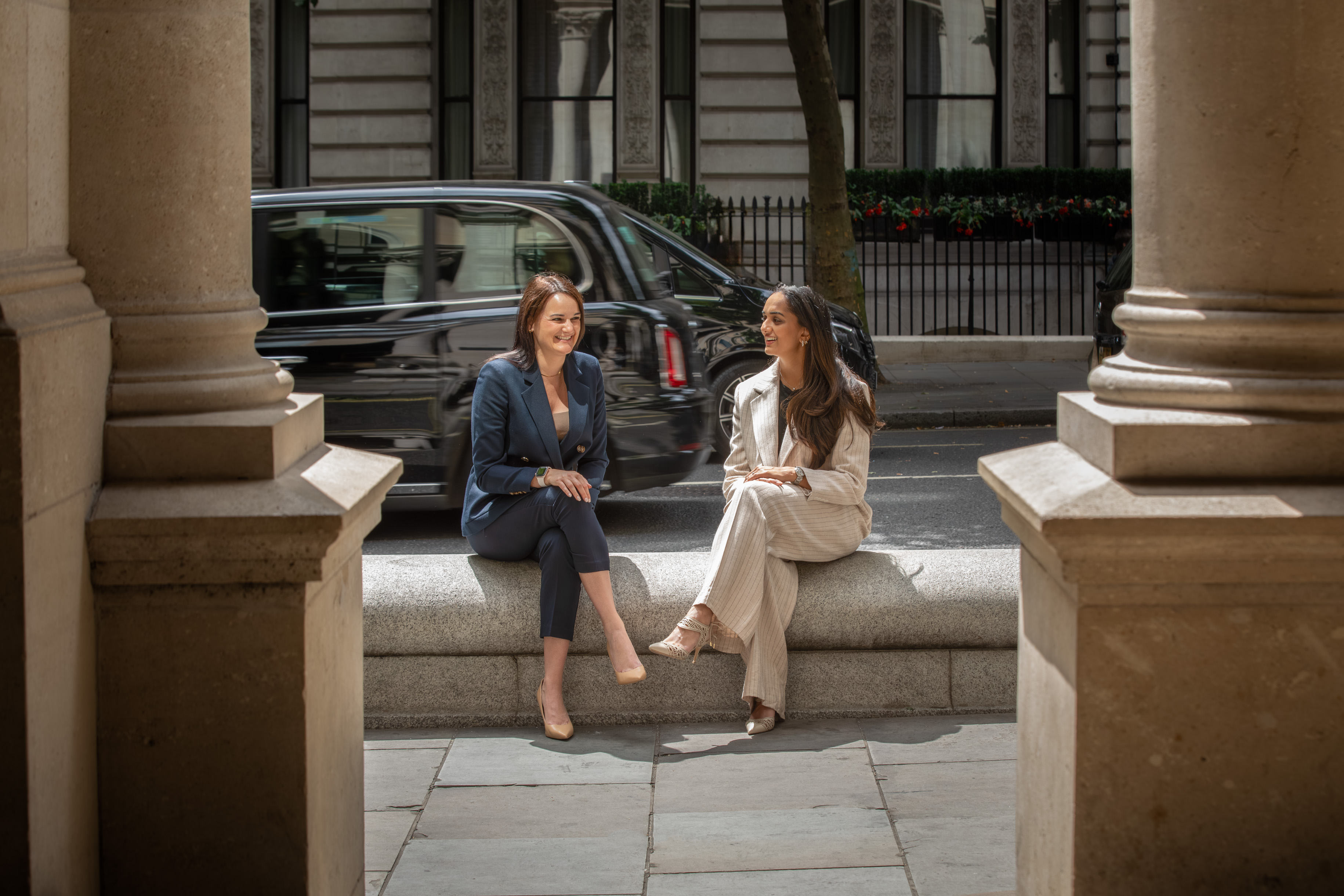 Two women talking to each other on a bench