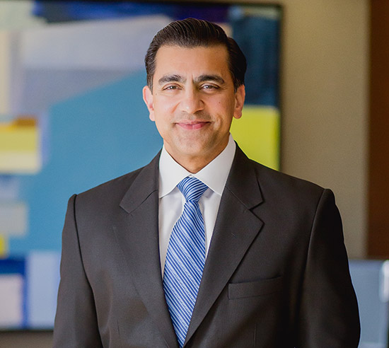 The company's CEO smiles in his office.