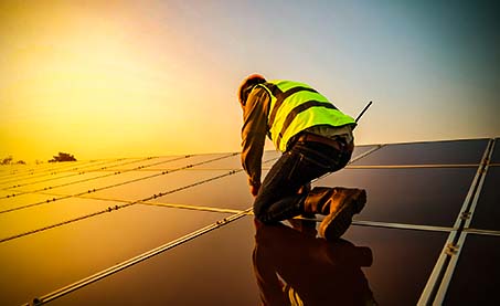 Person working on solar panels